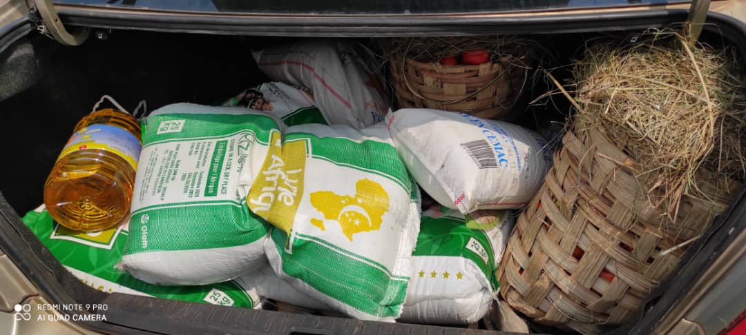 Loading the car for a home delivery to a widow who could not travel