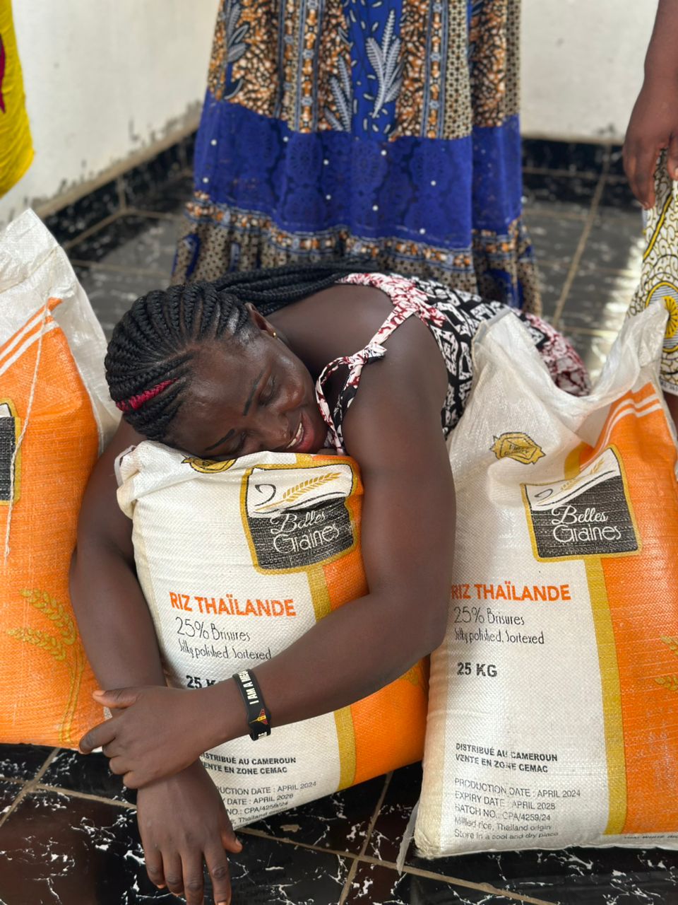 Pure joy — a sister embracing the rice that will feed her children