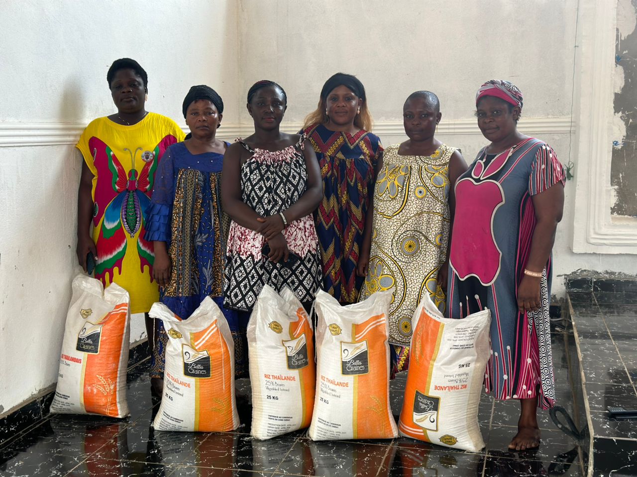 Mothers receiving 25 kg rice bags through the Open Market